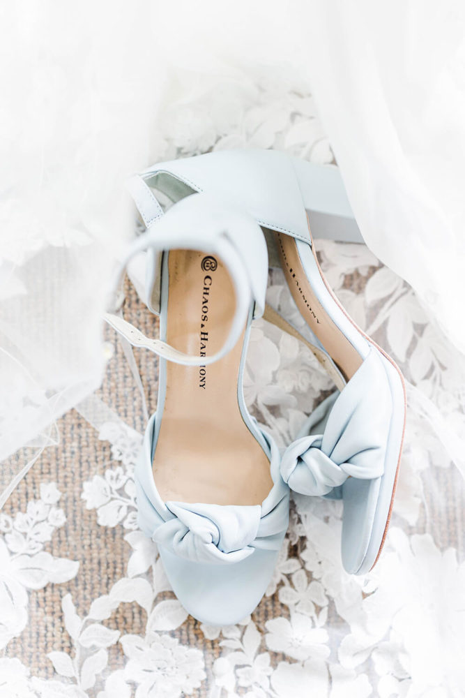 blue chunky heels strap sandals draped in a white wedding veil