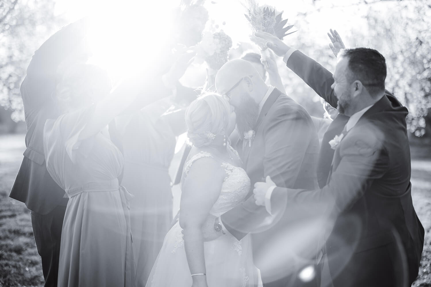 full figured bride kissing a bearded groom